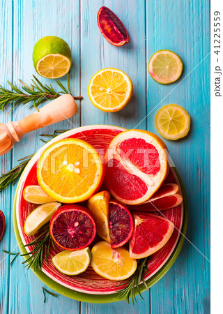 Sliced citrus fruit on the plate on blue wooden background Sliced citrus fruit on the plate on blue wooden background 41225559