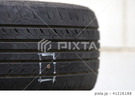 Tires on the floor are damaged by hitting nails  41226188