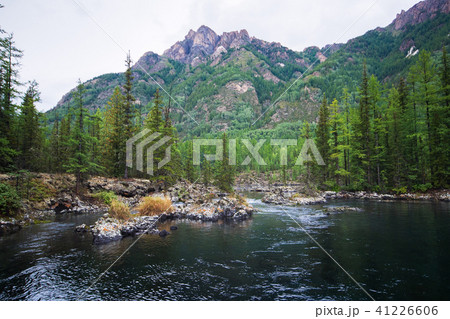 Wonderful lake wide panorama. Scenic summer landscape, mountains and blue cloudy sky at background Wonderful lake wide panorama. Scenic summer landscape, mountains and blue cloudy sky at background 41226606