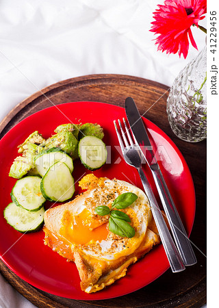 Healthy breakfast served to bed with flowers Healthy breakfast served to bed with flowers 41229456