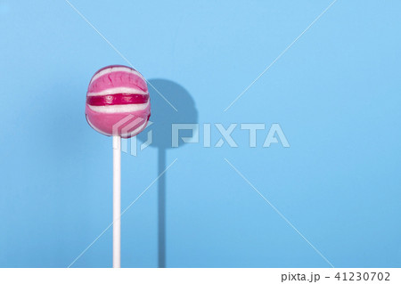 Pink Lolipop candy with shadow on pastel blue background 41230702