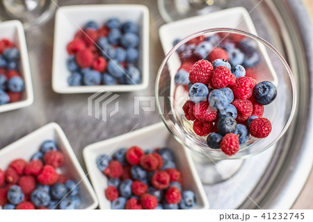 Berries of blueberries, raspberries in a beautiful vase on the table 41232745