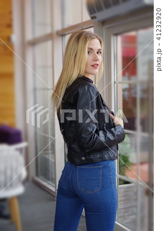 Beautiful young blonde woman posing in cozy cafe. Beautiful young blonde woman posing in cozy cafe. 41232920