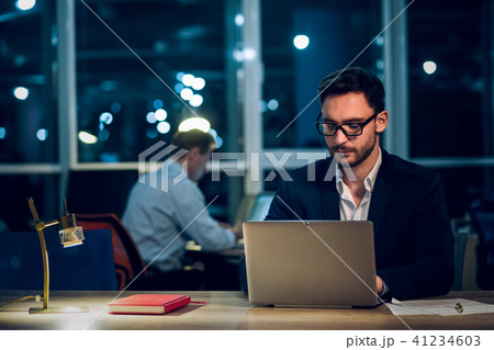 Young businessman staying up late working. Young businessman staying up late working. 41234603
