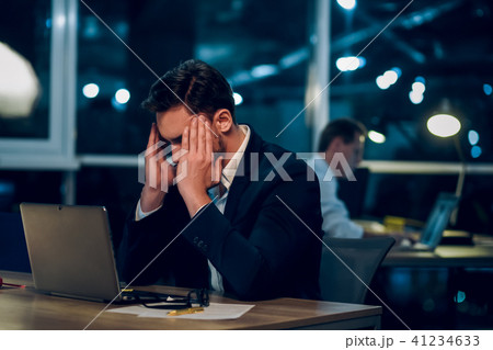 Young businessman staying up late working. Young businessman staying up late working. 41234633