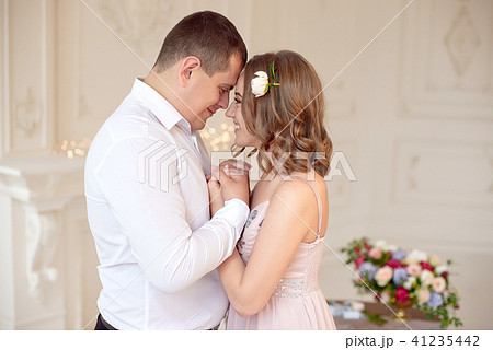 close-up young happy couple kissing in white room 41235442