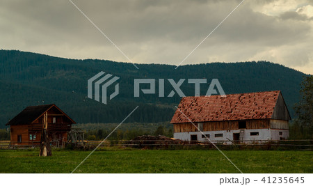 Wide shot of an abandoned log house 41235645