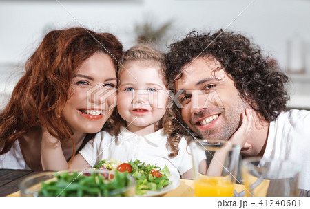 Positive family having healthy dinner with enjoyment  41240601