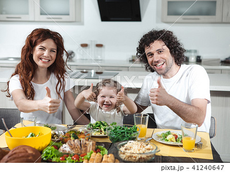 Cheerful parents and child showing ok sign while eating 41240647