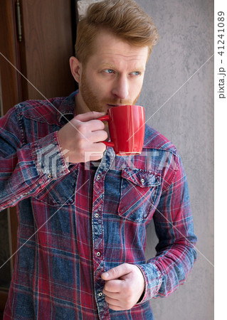 Attractive guy drinking coffee. Attractive guy drinking coffee. 41241089