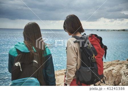 Active girls enjoying sea view after hiking Active girls enjoying sea view after hiking 41241386
