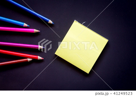 Paper with crayon on black backgrounds Paper with crayon on black backgrounds 41249523