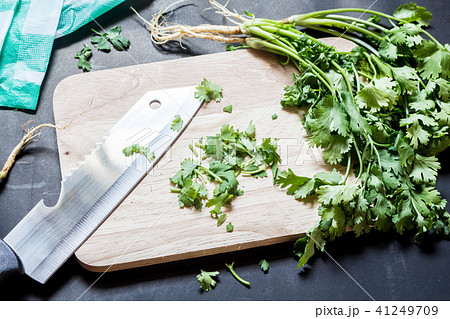 Parsley leaves with a knife on a cutting board 41249709