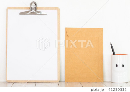 Paper in clipboard and notebook on wooden table Paper in clipboard and notebook on wooden table 41250332