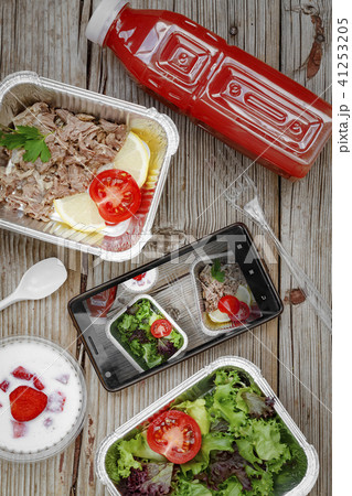 Healthy food delivery. Concept: Proper nutrition, catering, business lunch. Smartphone, wholesome 41253205