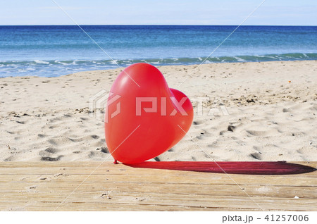 red heart-shaped balloon on the beach red heart-shaped balloon on the beach 41257006