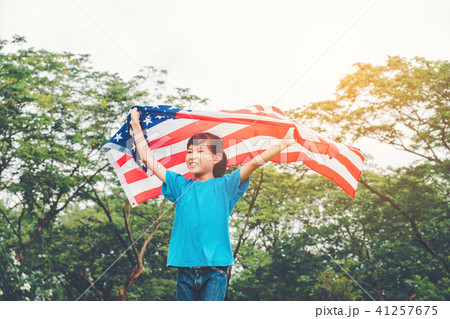 Happy kid little child running with American flag Happy kid little child running with American flag 41257675