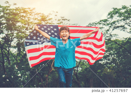 Happy kid little child running with American flag Happy kid little child running with American flag 41257697