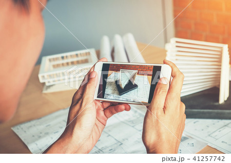 Architect using smart phone photograph model 41257742