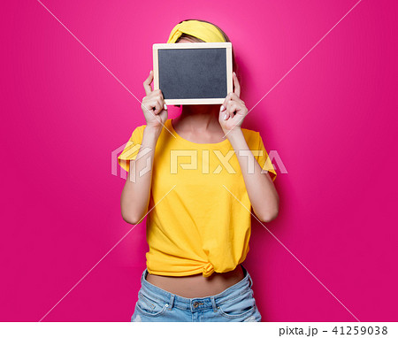 Girl in yellow t-shirt with little blackboard 41259038