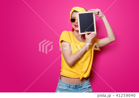Girl in yellow t-shirt with little blackboard Girl in yellow t-shirt with little blackboard 41259040