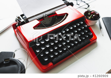 Workplace with bright red vintage typewriter 41260909
