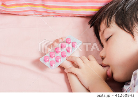 Little Asian Boy Sleep with Medicine panel in hand. 41260943