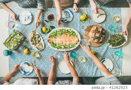 Family or friends having seafood summer dinner 41262025