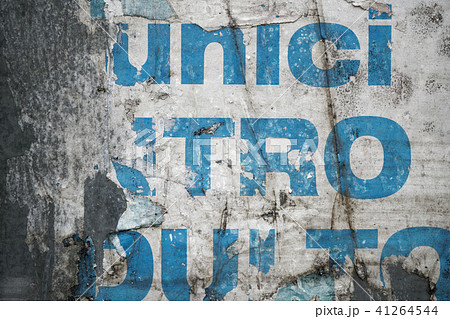 Torn poster on tin textured wall. Ripped newspaper Torn poster on tin textured wall. Ripped newspaper 41264544