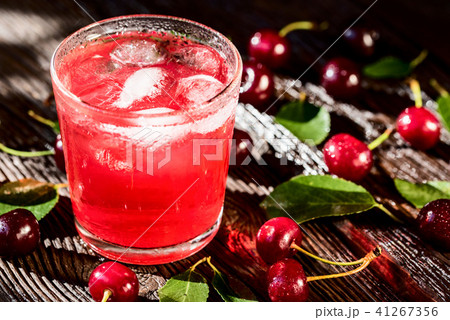 Fresh cherries and ice cherry fruit drink on wood Fresh cherries and ice cherry fruit drink on wood 41267356