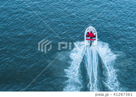 Top view of people in small motor boat on river 41267361