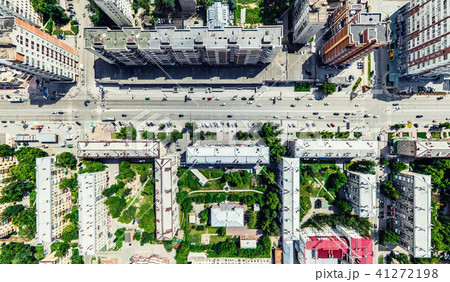 Aerial city view with crossroads and roads, houses, buildings, parks and parking lots. Sunny summer Aerial city view with crossroads and roads, houses, buildings, parks and parking lots. Sunny summer 41272198
