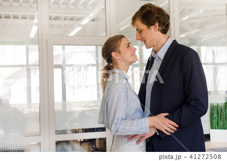 Couple in love standing in office Couple in love standing in office 41272508