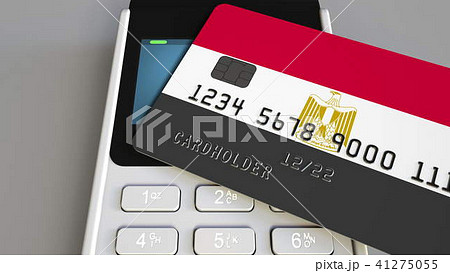 Payment or POS terminal with credit card featuring flag of Egypt. Egyptian retail commerce or Payment or POS terminal with credit card featuring flag of Egypt. Egyptian retail commerce or 41275055