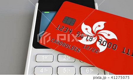 Payment or POS terminal with credit card featuring flag of Hong Kong. Retail commerce or banking 41275075