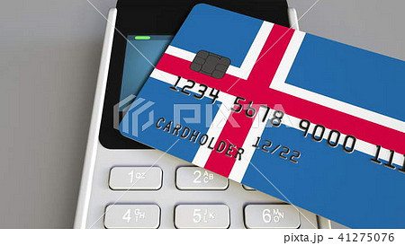 Payment or POS terminal with credit card featuring flag of Iceland. Icelandic retail commerce or 41275076