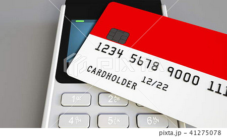 Payment or POS terminal with credit card featuring flag of Indonesia. Indonesian retail commerce or 41275078