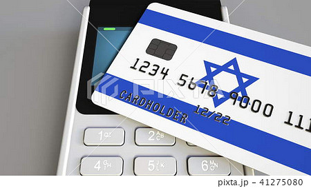 Payment or POS terminal with credit card featuring flag of Israel. Israeli retail commerce or 41275080