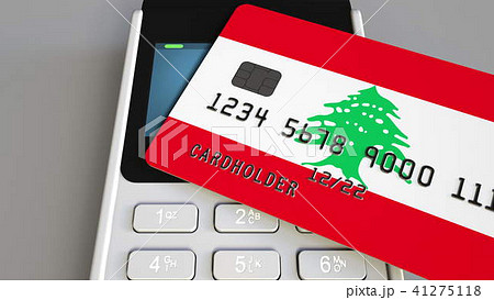 Payment or POS terminal with credit card featuring flag of Lebanon. Lebanese retail commerce or Payment or POS terminal with credit card featuring flag of Lebanon. Lebanese retail commerce or 41275118