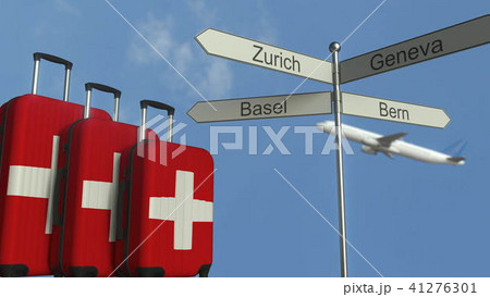 Travel baggage featuring flag of Switzerland, airplane and city sign post. Swiss tourism conceptual 41276301