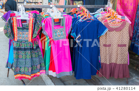 Clothes hanging on a rack in a shopping mall. 41280114