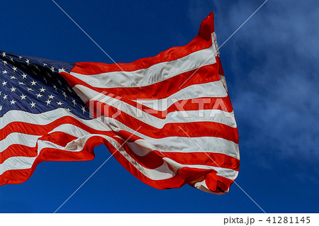 The American flag waving in blue sky The American flag waving in blue sky 41281145