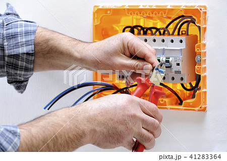 Electrician at work on an electrical panel 41283364