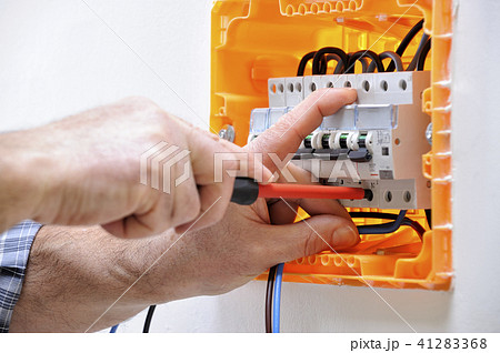 Electrician at work on an electrical panel 41283368