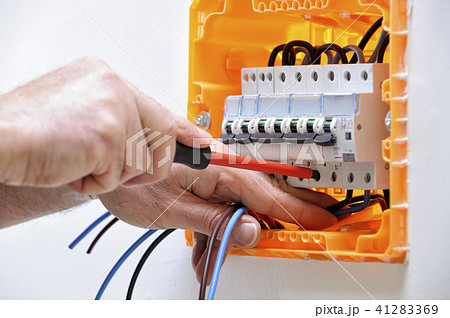 Electrician at work on an electrical panel 41283369