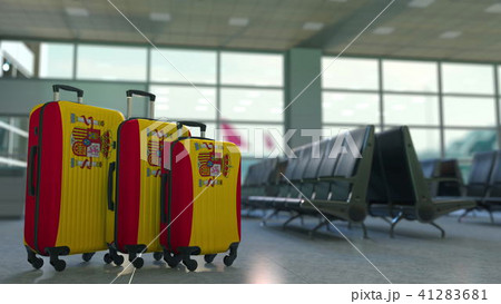 Travel suitcases featuring flag of Spain. Spanish tourism conceptual 3D rendering 41283681