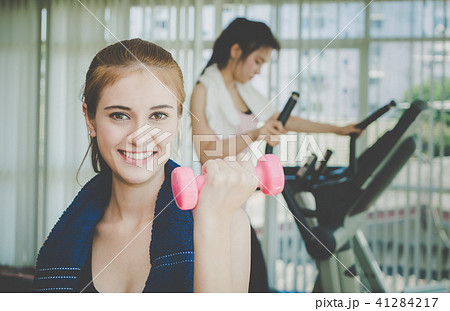 Asian woman is lifting dumbbell in fitness 41284217