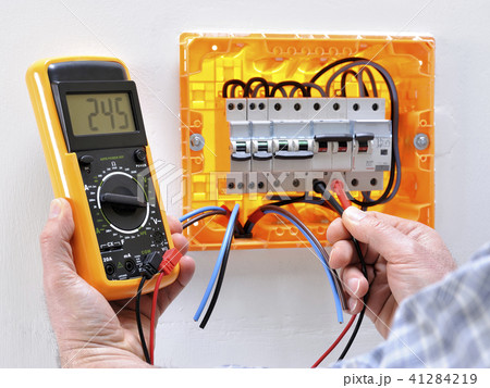 Electrician at work on an electrical panel 41284219