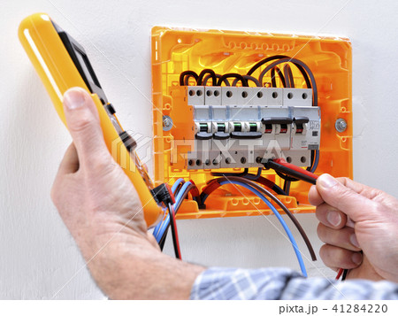 Electrician at work on an electrical panel 41284220