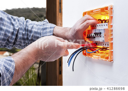 Electrician at work on an electrical panel 41286698